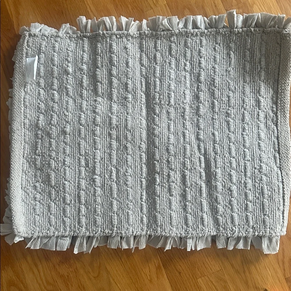 Bathroom rug in light grayish/taupe in color